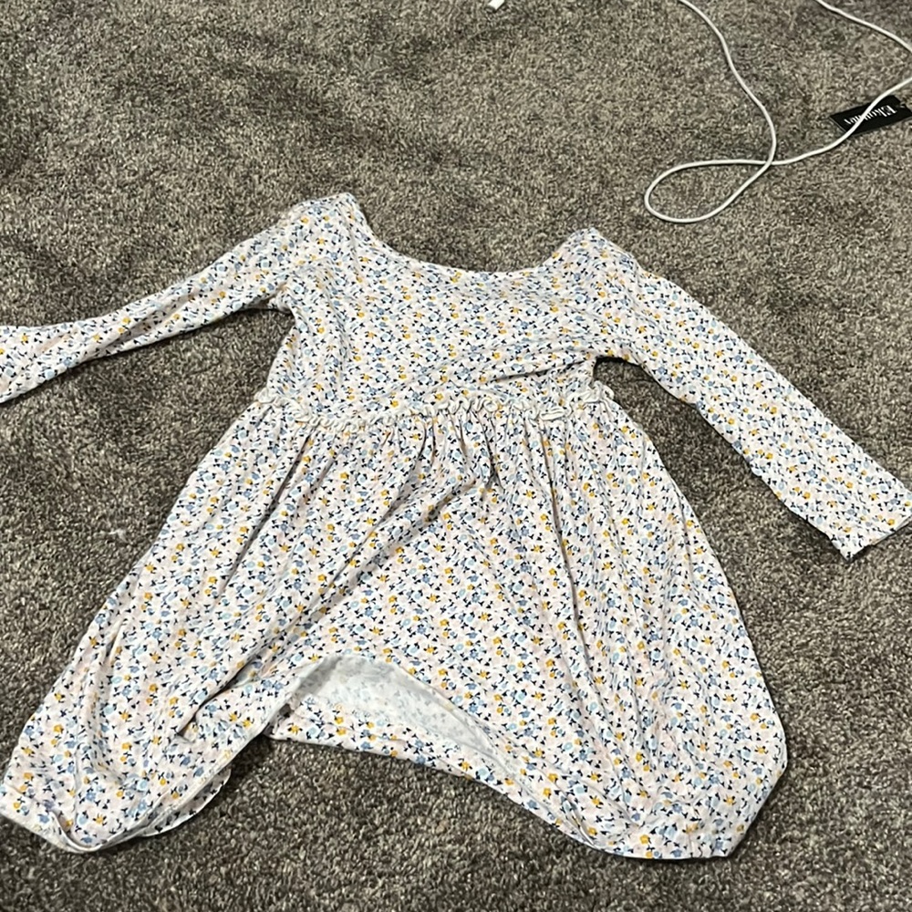 White dress with blue, pink, and yellow flowers on it